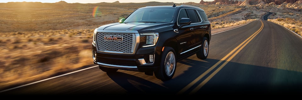 2024 GMC Yukon driving on the road.