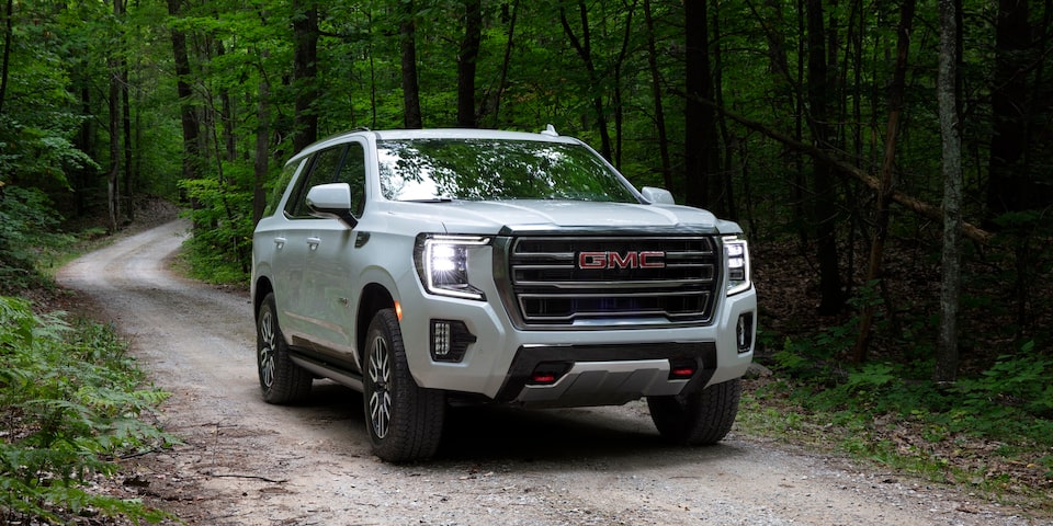 2024 GMC Yukon driving outdoors.