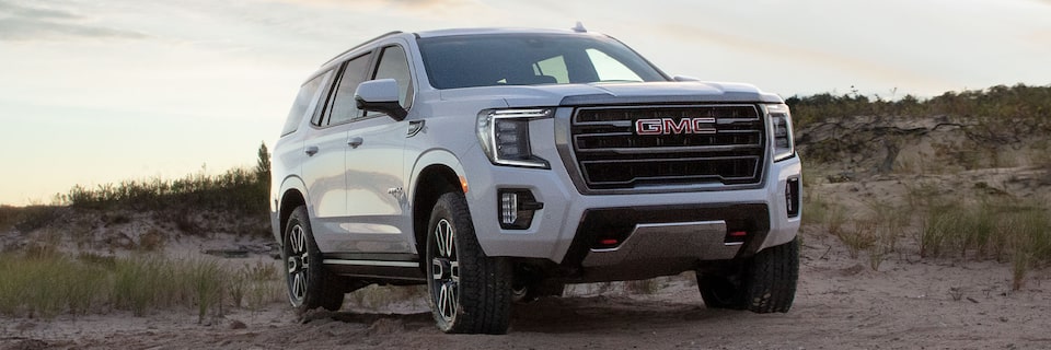 2024 GMC Yukon AT4 parked on a rugged terrain.