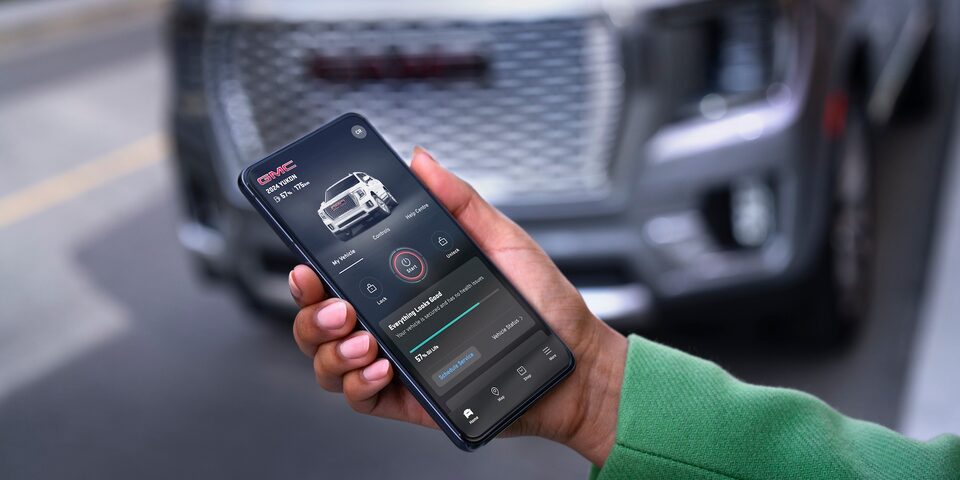 A person accessing the myGMC Mobile app through his smartphone.