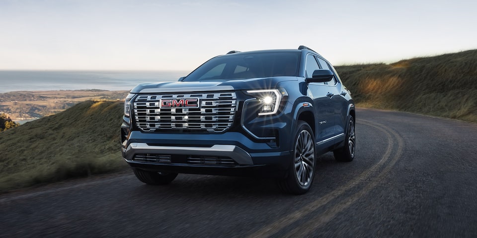 Front Three-Quarters View of a 2026 GMC Terrain Denali Luxury SUV Driving Down the Coast.