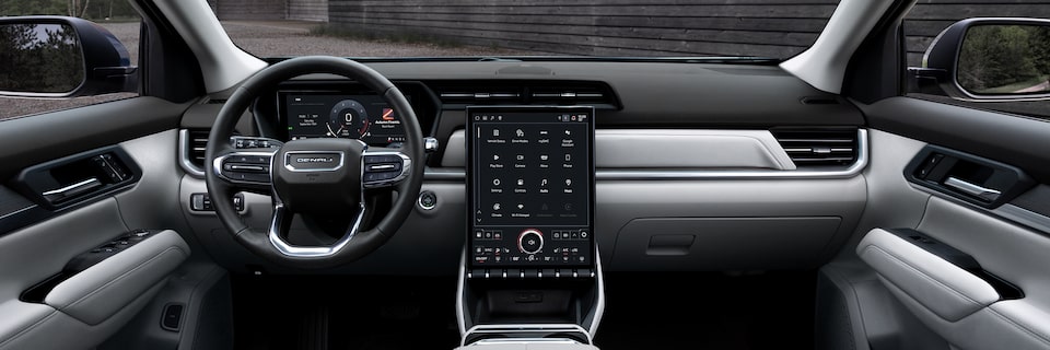 Interior View of the Dashboard, Steering Wheel and Infotainment System in the 2026 GMC Terrain Denali Luxury SUV.