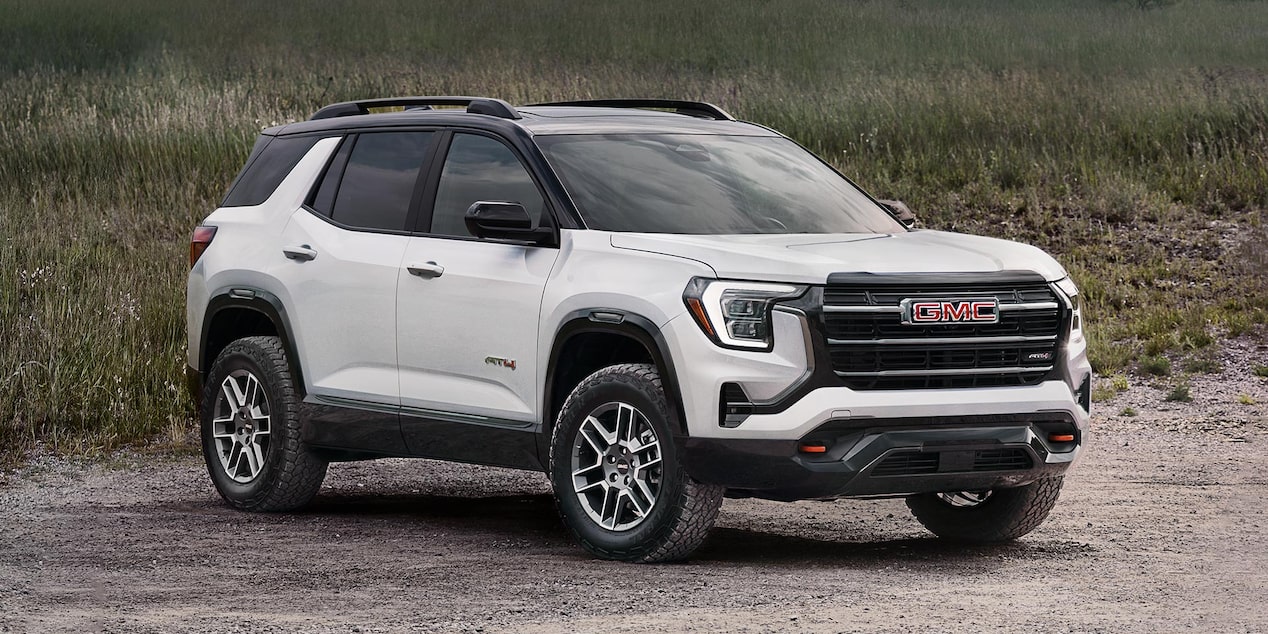 Front-side view of the 2026 GMC Terrain AT4 parked near a grassy terrain.