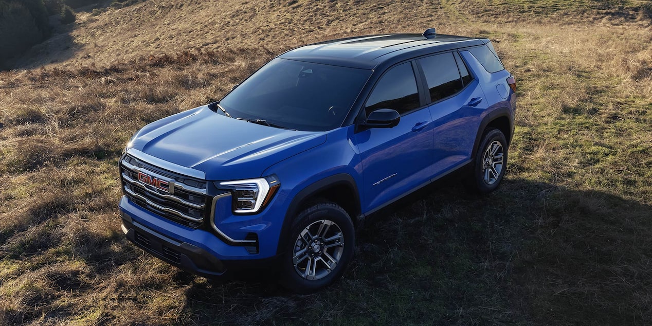 Front-side view of the 2026 GMC Terrain Elevation parked on a grassy terrain.