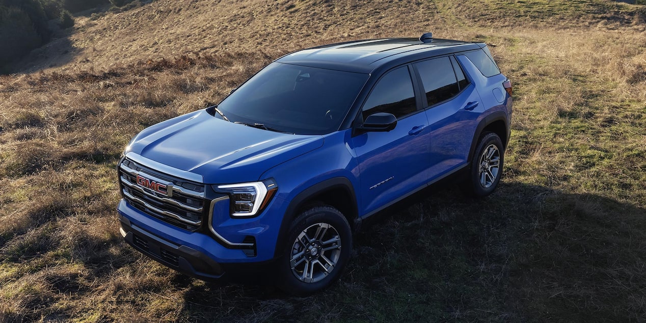 Front-side view of the 2026 GMC Terrain Elevation parked on a grassy terrain.