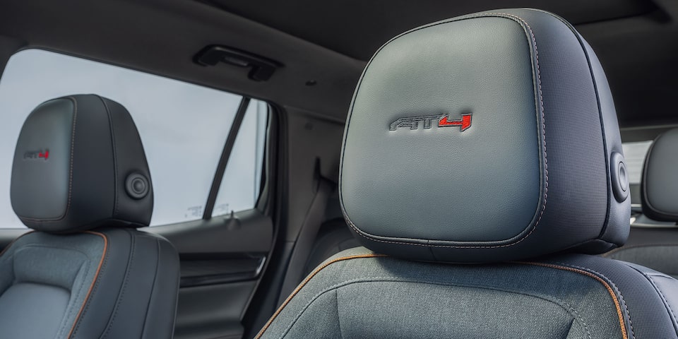 Close up view of the AT4 badging etched on the seat headrests of the 2026 GMC Terrain AT4.