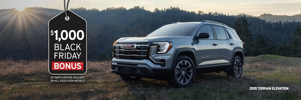 Three 2026 GMC Terrain vehicles parked beside each other by the mountainside.