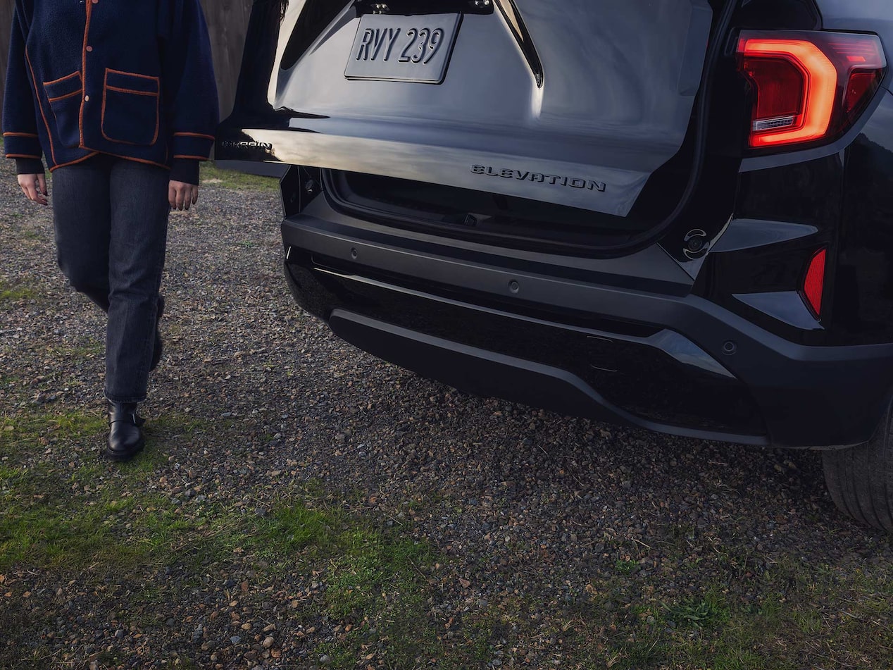 Close up view of a person utilizing the Autosense Power Liftgate function on the 2026 GMC Terrain.