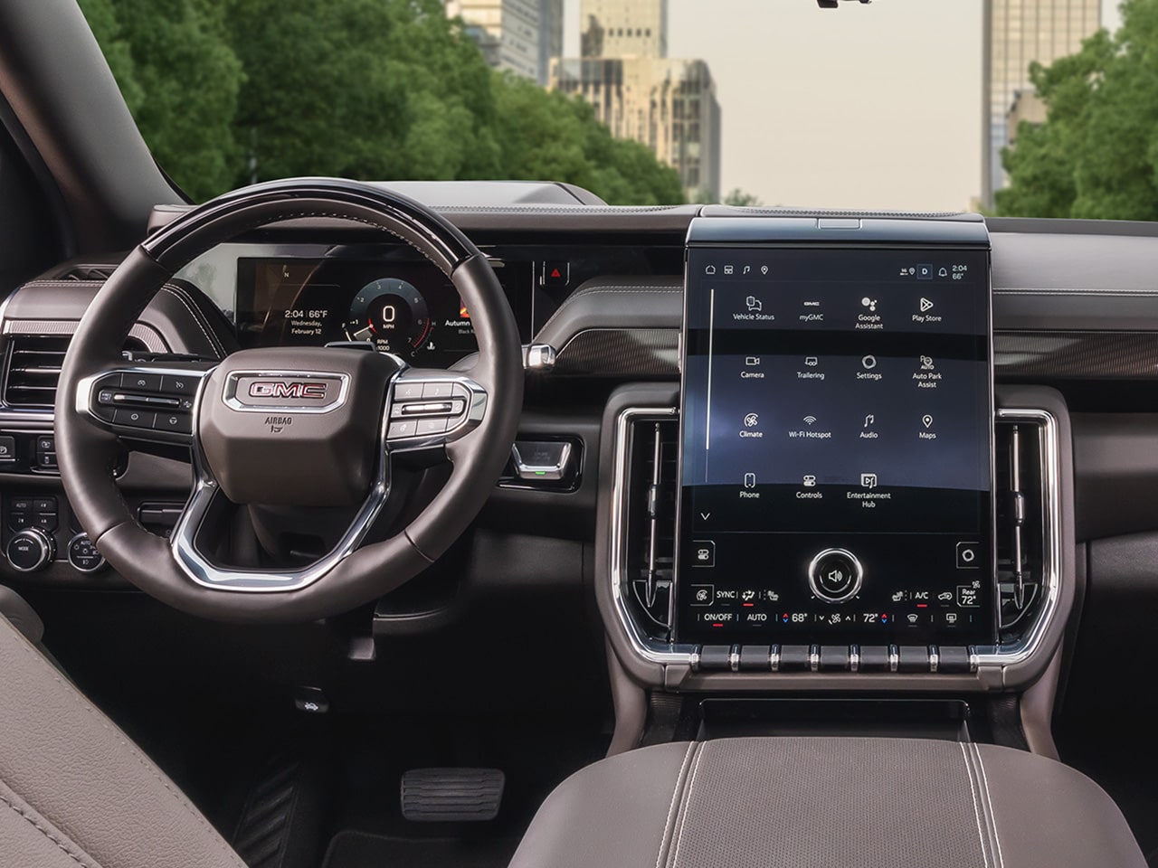 Interior View of the Steering Wheel, Dashboard, and Infotainment System inside the 2026 GMC Yukon Large SUV.