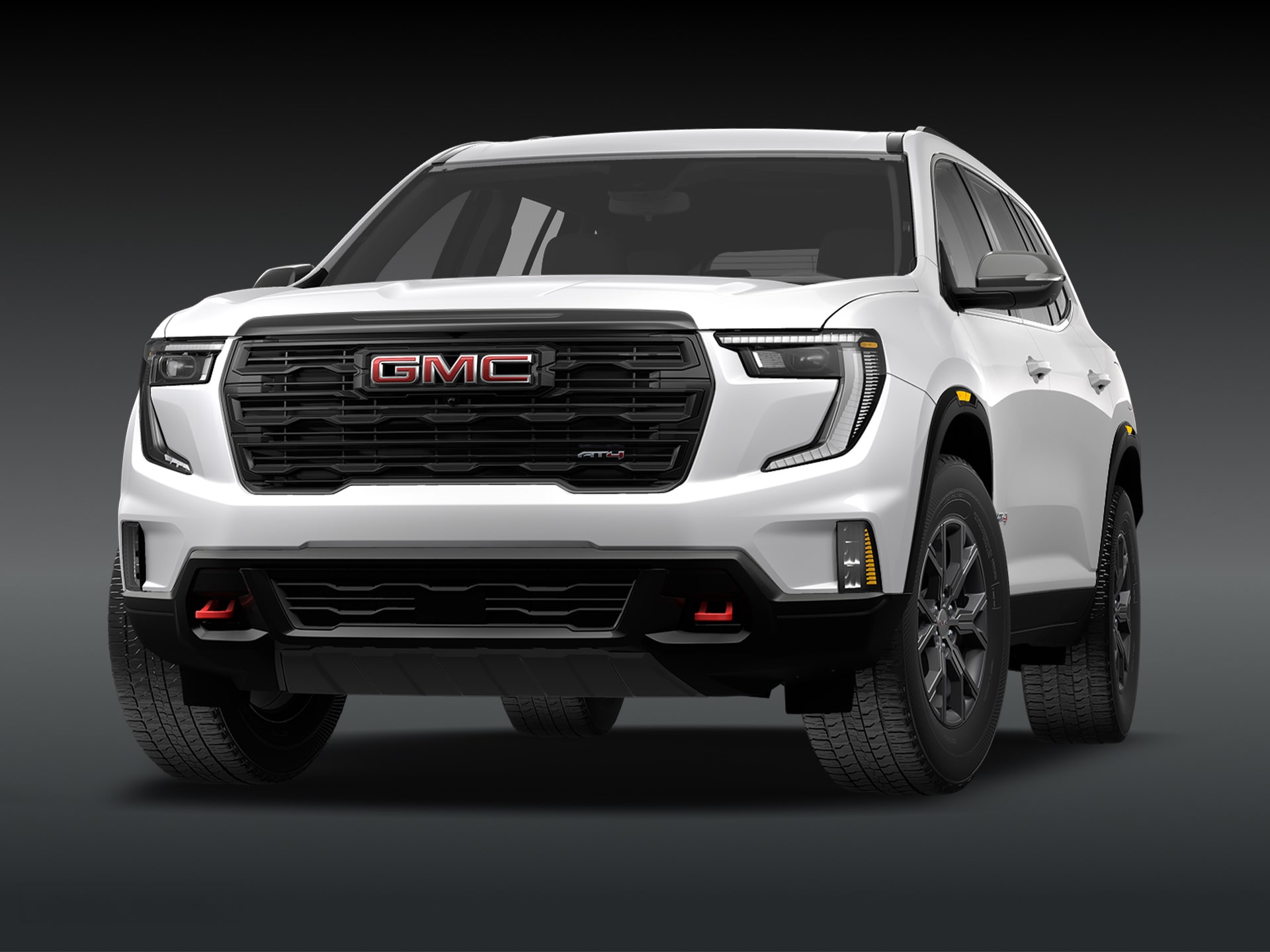 Vue de trois quarts avant du SUV GMC Acadia AT4 2027 « Summit White » sur fond sombre.