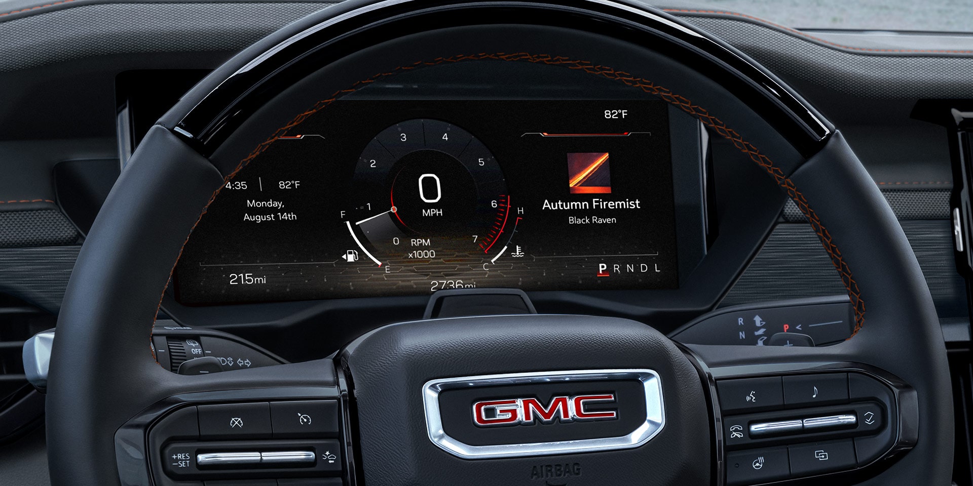 Une vue intérieure d’un volant GMC Acadia 2027 et d’un tableau de bord numérique.