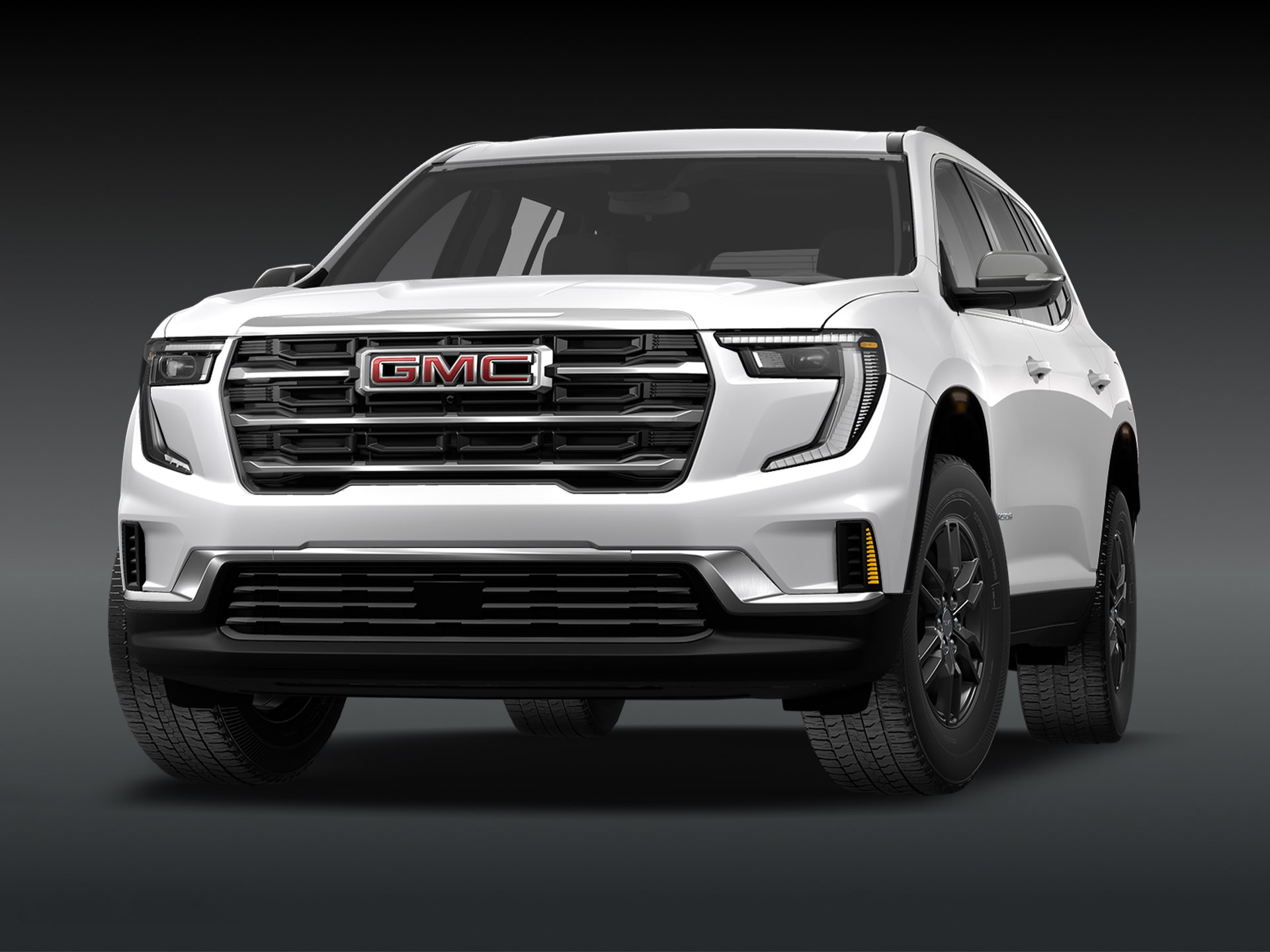 Vue de trois quarts avant du SUV GMC Acadia Elevation 2027 « Summit White » sur fond sombre.