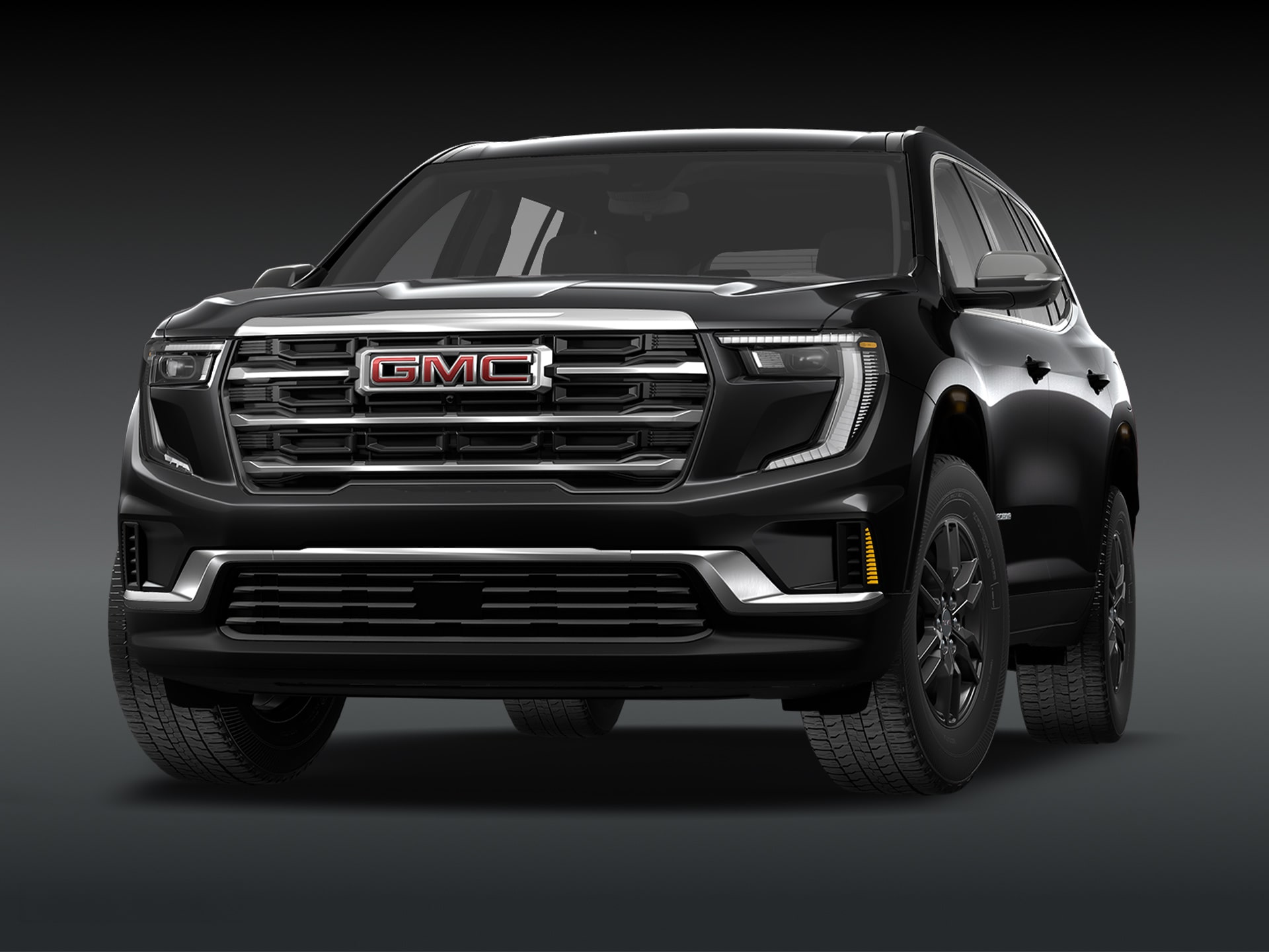 Vue de trois quarts avant du SUV GMC Acadia Elevation 2027 noir sur fond sombre.
