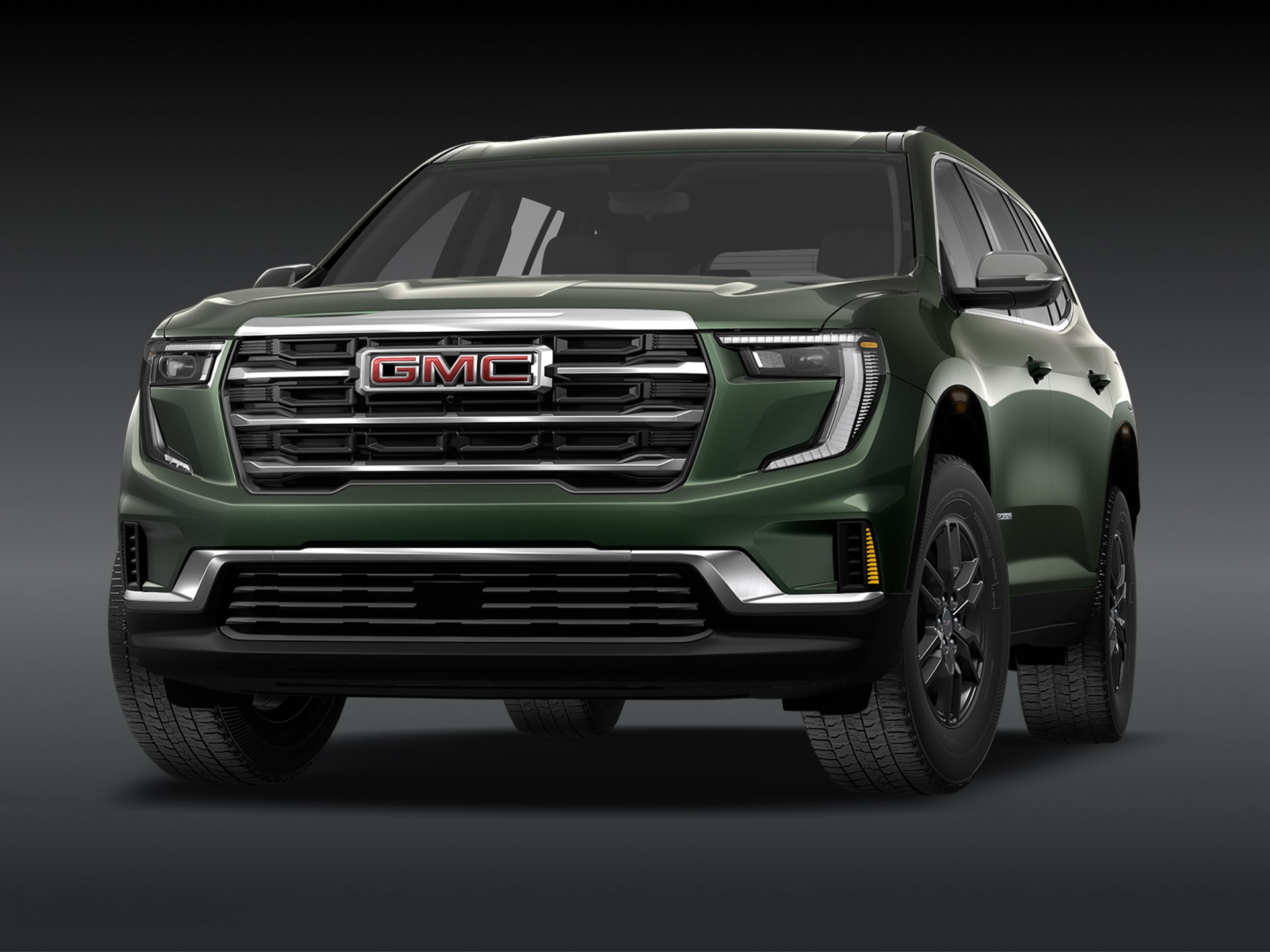 Vue de trois quarts avant du SUV GMC Acadia Elevation 2027 de couleur vert foncé, sur fond sombre.