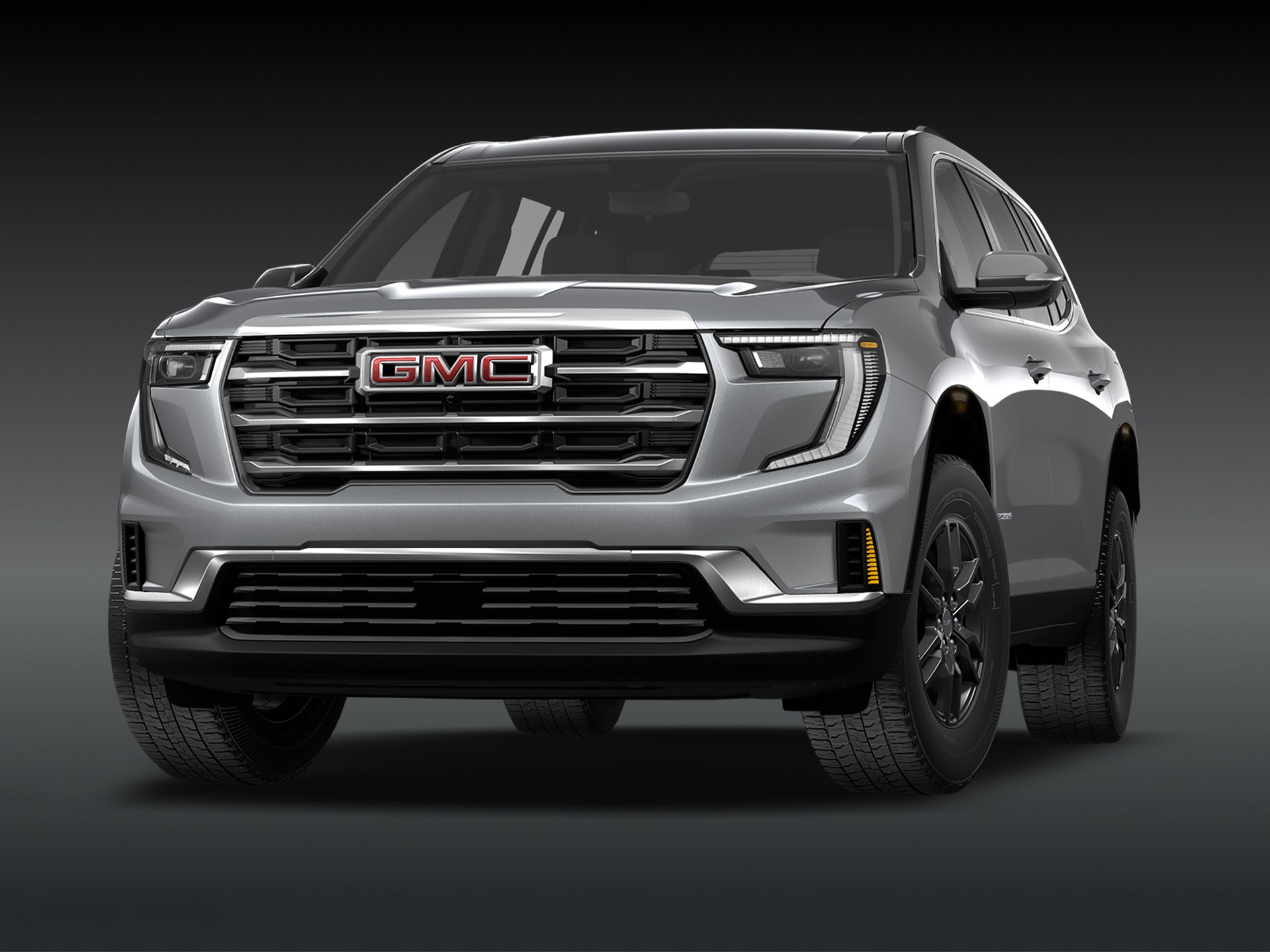 Vue de trois quarts avant du SUV GMC Acadia Elevation 2027 gris sur fond sombre.