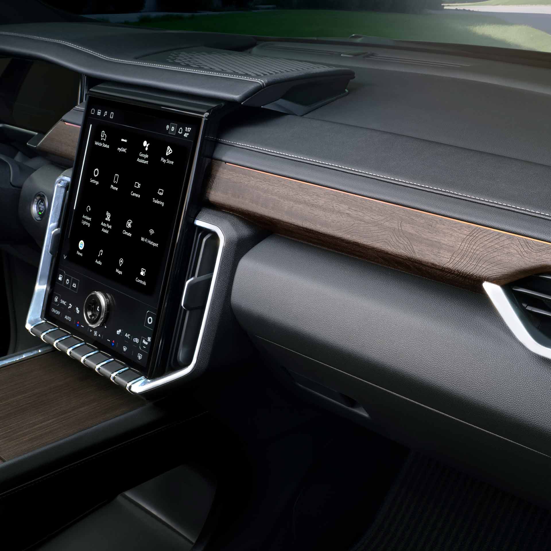 Le tableau de bord intérieur d’un VUS GMC Acadia 2027 avec un grand écran tactile et des finitions en bois.