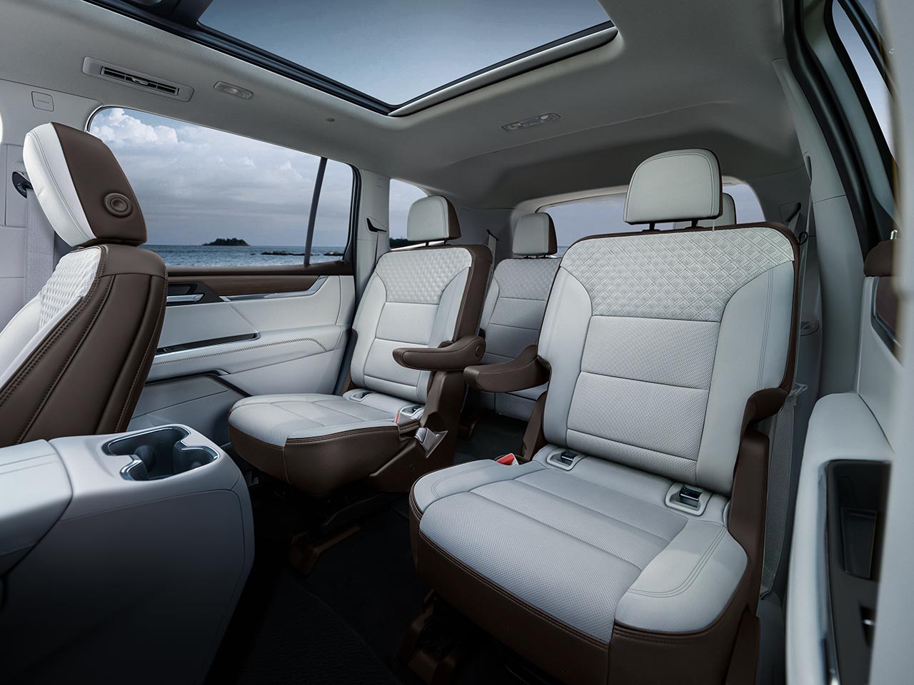 Vue du tableau de bord des sièges intérieurs d’un VUS GMC Acadia Denali 2027 avec sièges en cuir blanc.