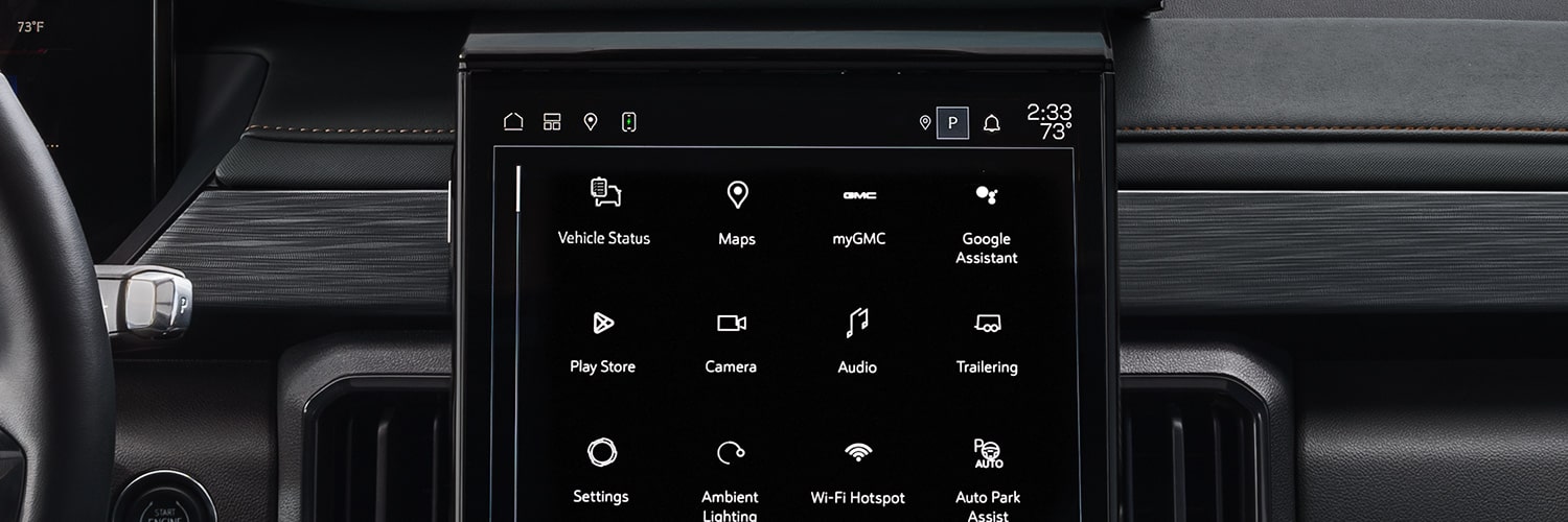 Une vue intérieure du système d’infodivertissement d’un véhicule GMC Acadia 2027 affichant diverses icônes d’application comme cartes, myGMC et paramètres.