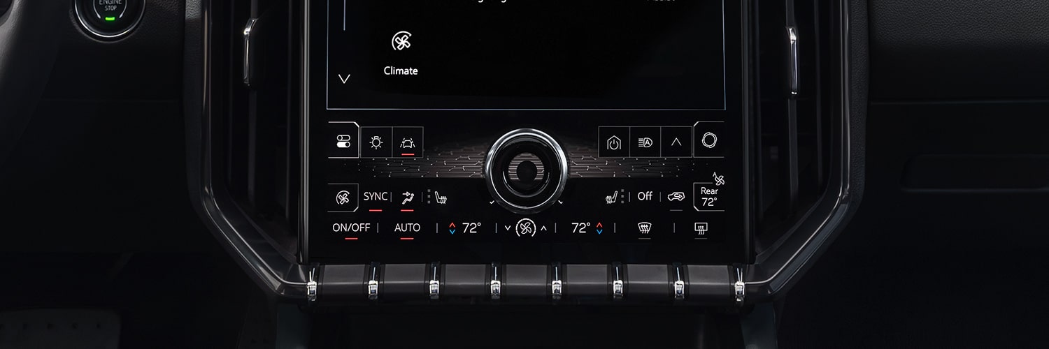 Une vue intérieure du système d’infodivertissement d’un véhicule GMC Acadia 2027 affichant diverses icônes d’application comme cartes, myGMC et paramètres.