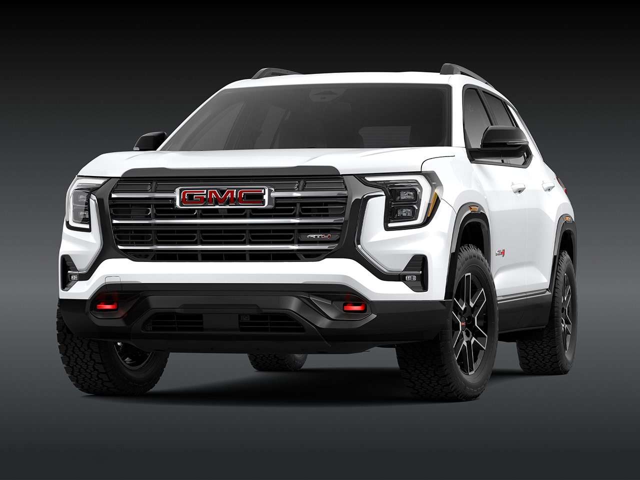Vue extérieure d’un SUV AT4 GMC Terrain blanc 2027 immaculé, avec une calandre proéminente et des pneus robustes.