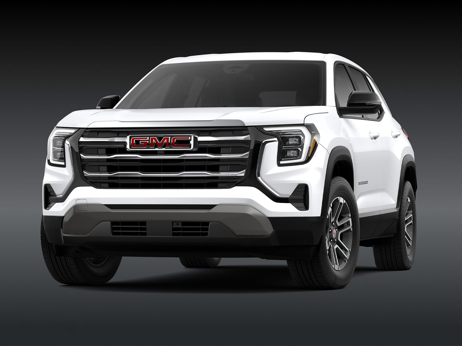 Vue de face d’un SUV GMC 2027 2027 en altitude de terrain blanc avec une calandre chromée.