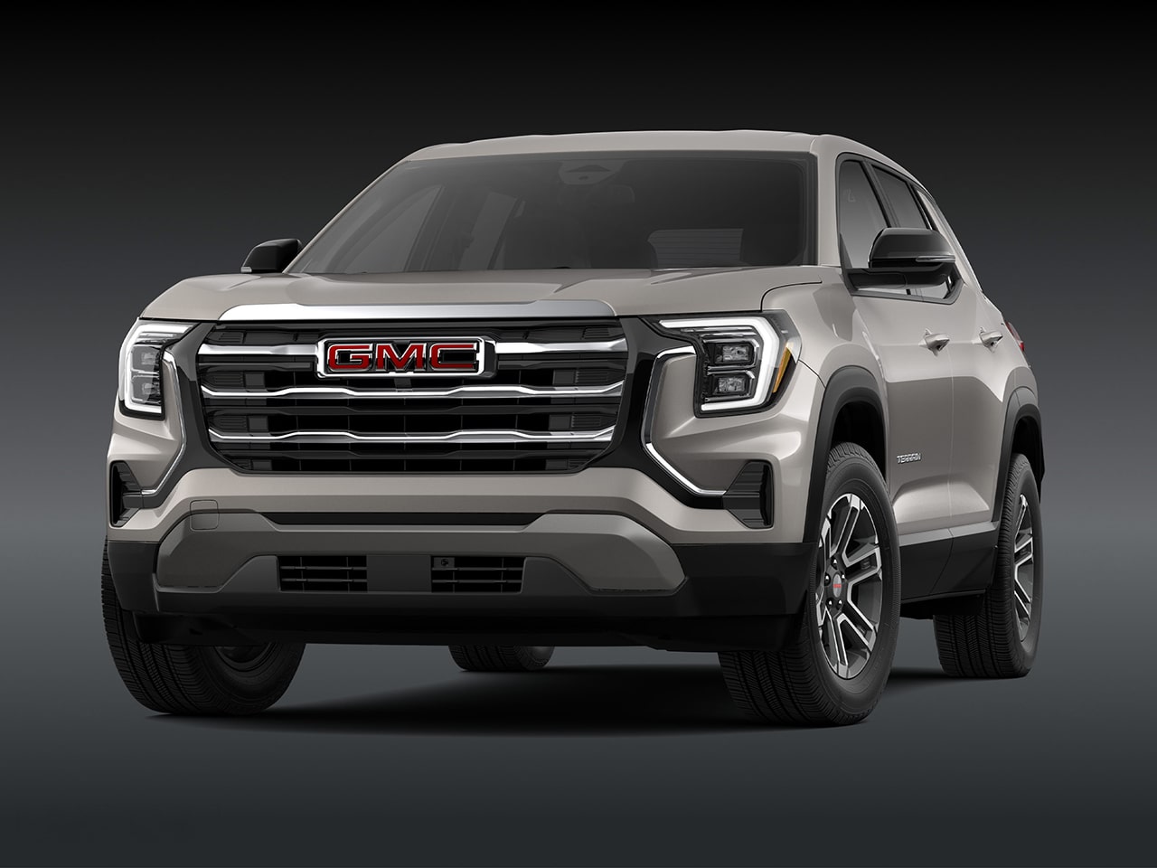 Vue de face d’un SUV GMC 2027 2027 en altitude terrain gris clair avec une calandre chromée.