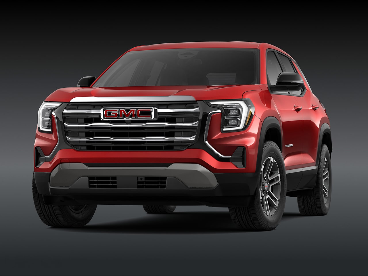 Vue de face d’un SUV GMC 2027 2027 en altitude de terrain rouge avec une calandre chromée.