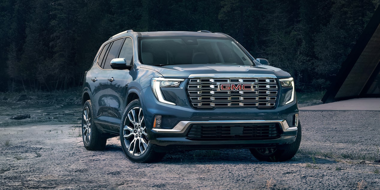 Vue latérale avant du VUS intermédiaire GMC Acadia stationné à la plage.