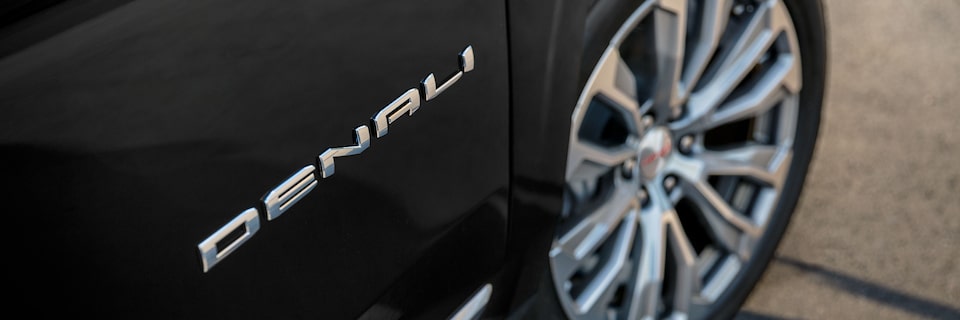 2023 GMC Denali insignia featuring luxury wheels.