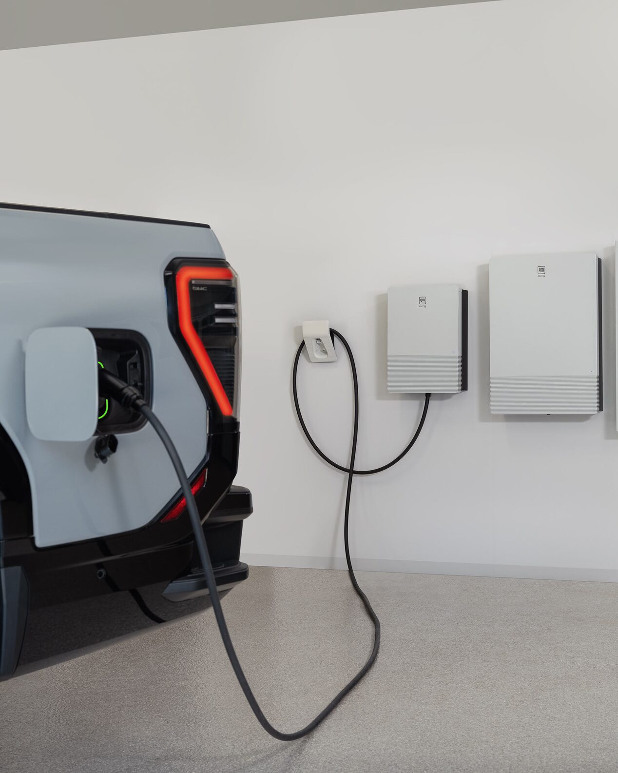 Close-up view of a GMC Electric Vehicle plugged into a Home Charging Station.