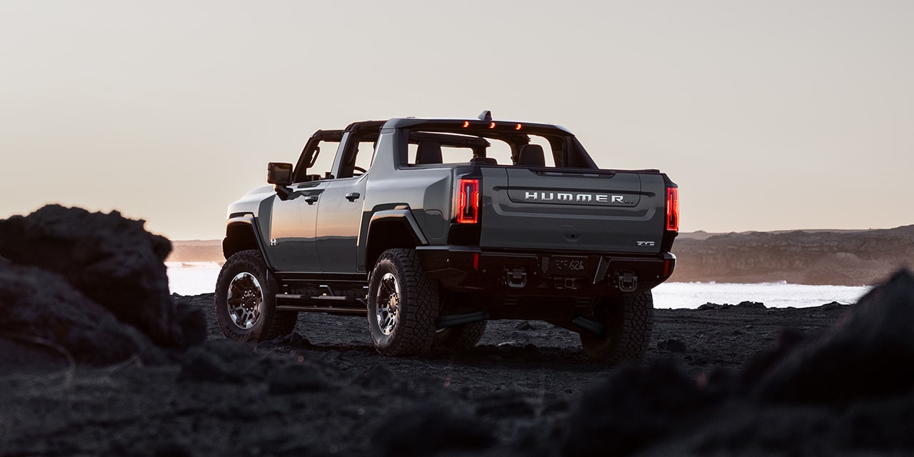 Back-Side view of the 2026 GMC Hummer EV Pickup Truck Parked on a Rocky Beach.