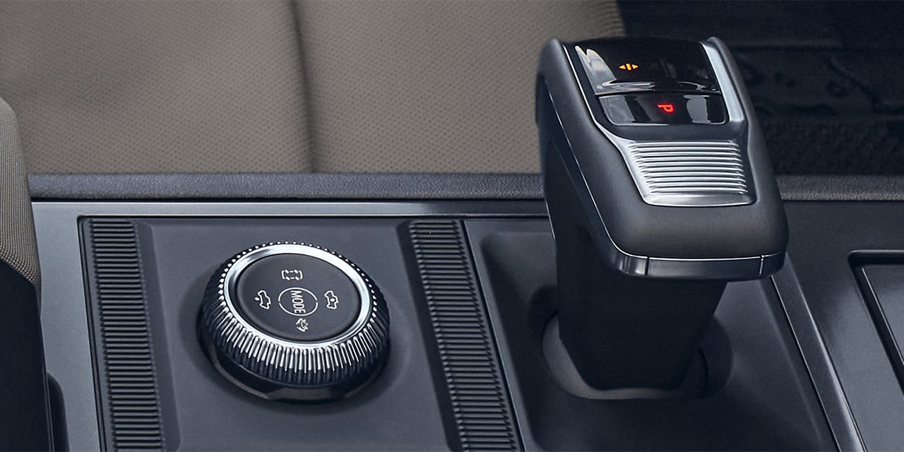 Close-up of the 2026 GMC Hummer EV Pickup Truck Selectable Driver Modes Dial and Shifter.