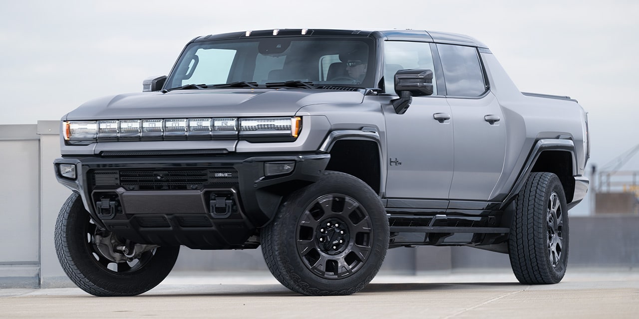 Front-Side View of the 2026 GMC Hummer EV Pickup Truck Parked Outdoors.