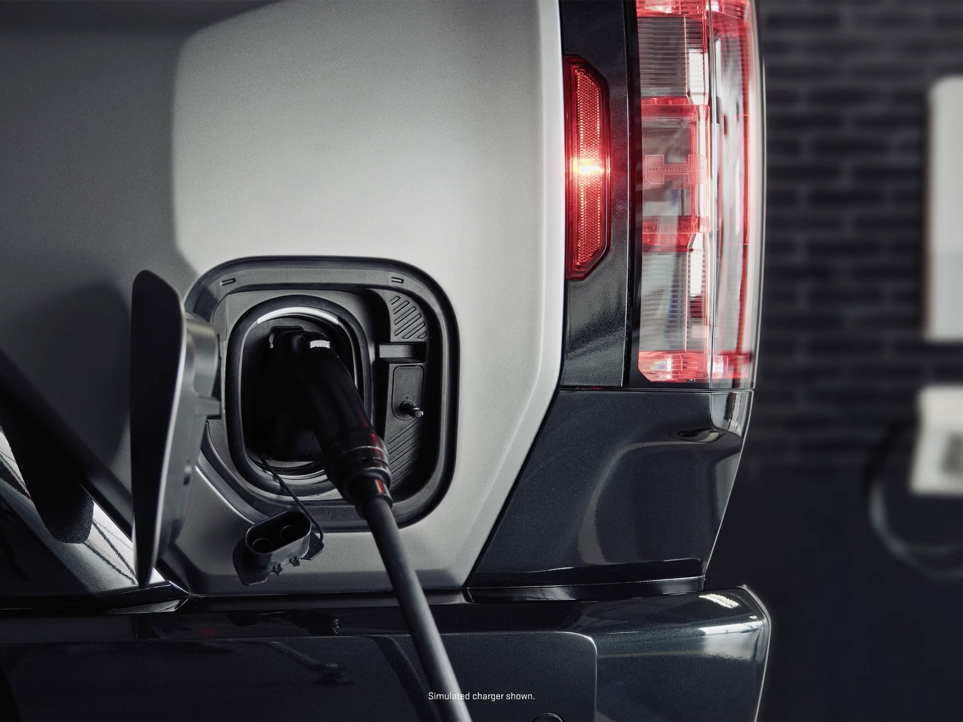 Close-up of an EV Charger plugged to the Charging Port of the 2026 GMC Hummer EV Pickup Truck.