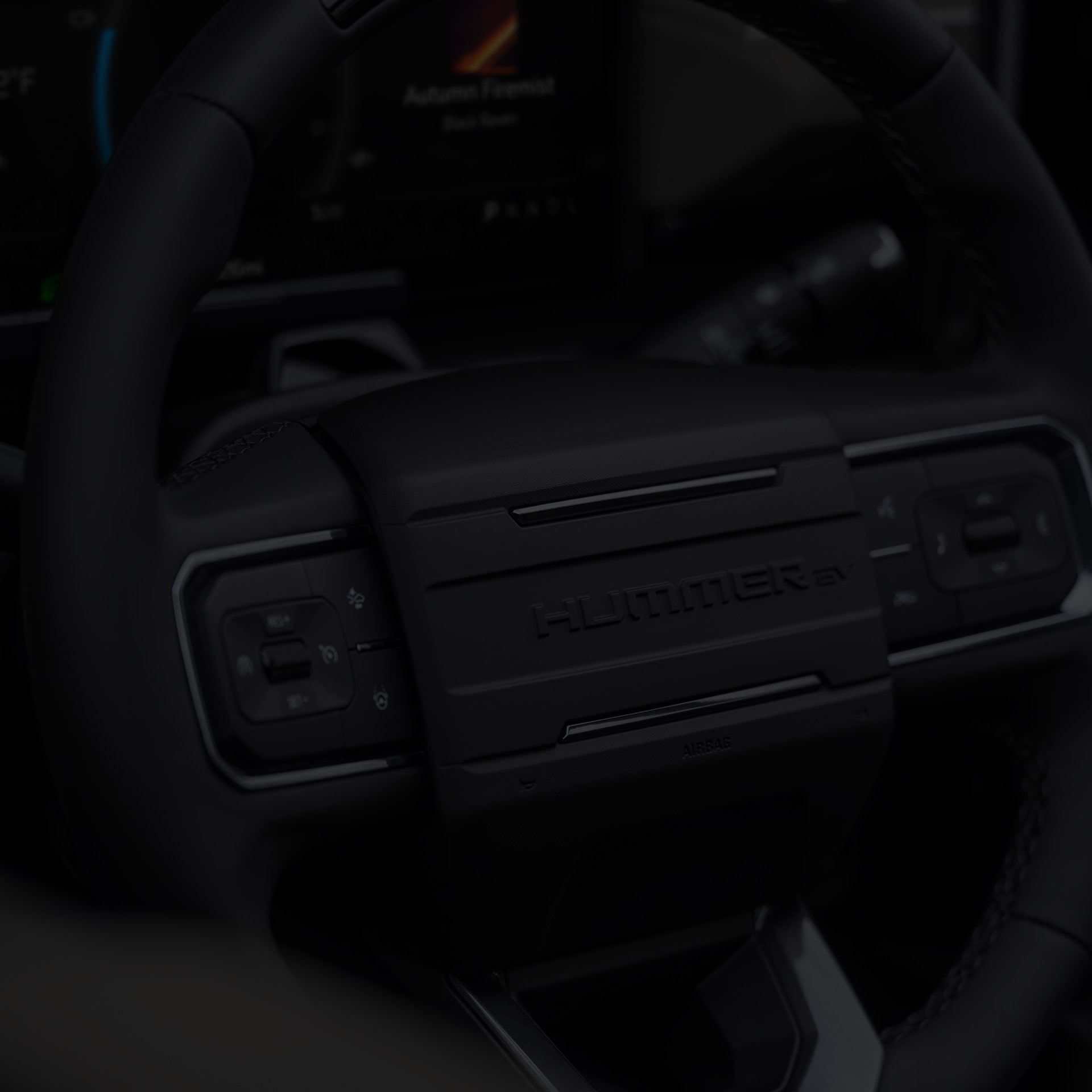 Close-up of the 2026 GMC Hummer EV Pickup Truck All-black Steering Wheel.