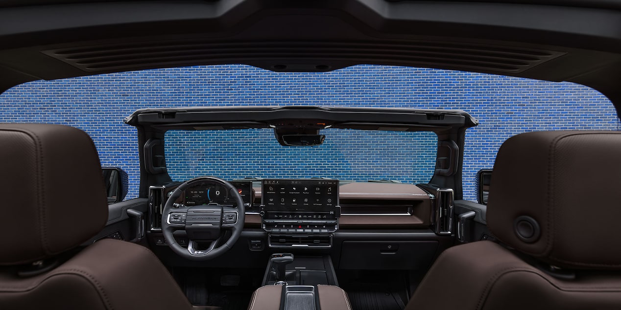 Rear Passenger's View of the Front Interiors of the 2026 GMC Hummer EV Pickup Truck.