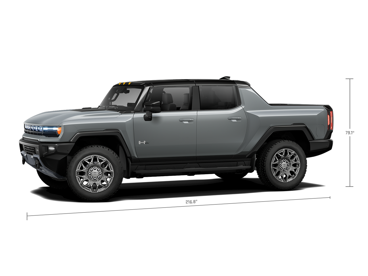 Side View of the 2026 GMC Hummer EV Pickup Truck Parked by a Wall.