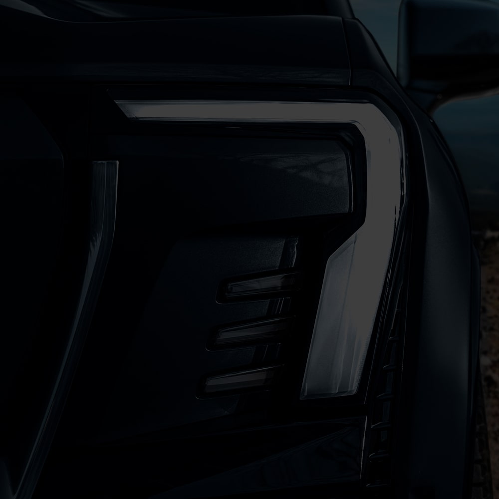 Vue rapprochée des phares du pick-up GMC Sierra EV 2026.