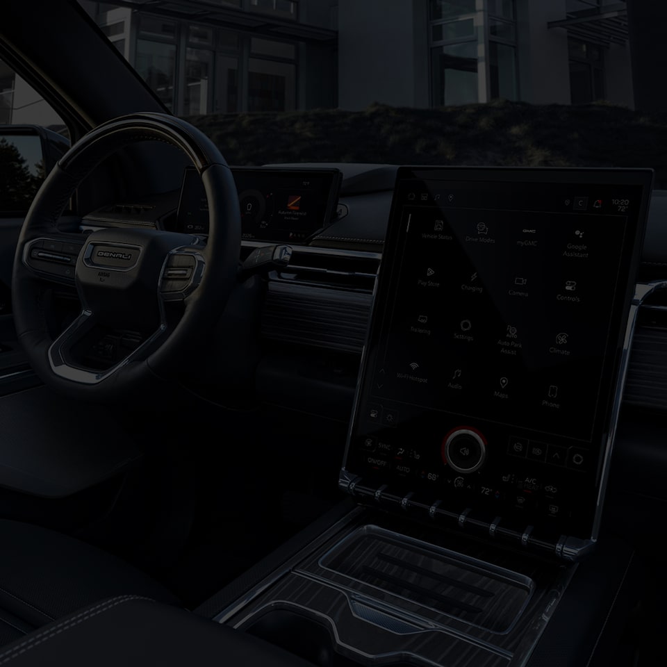 Le tableau de bord, le système d’infodivertissement et la console centrale du GMC Sierra EV 2026.