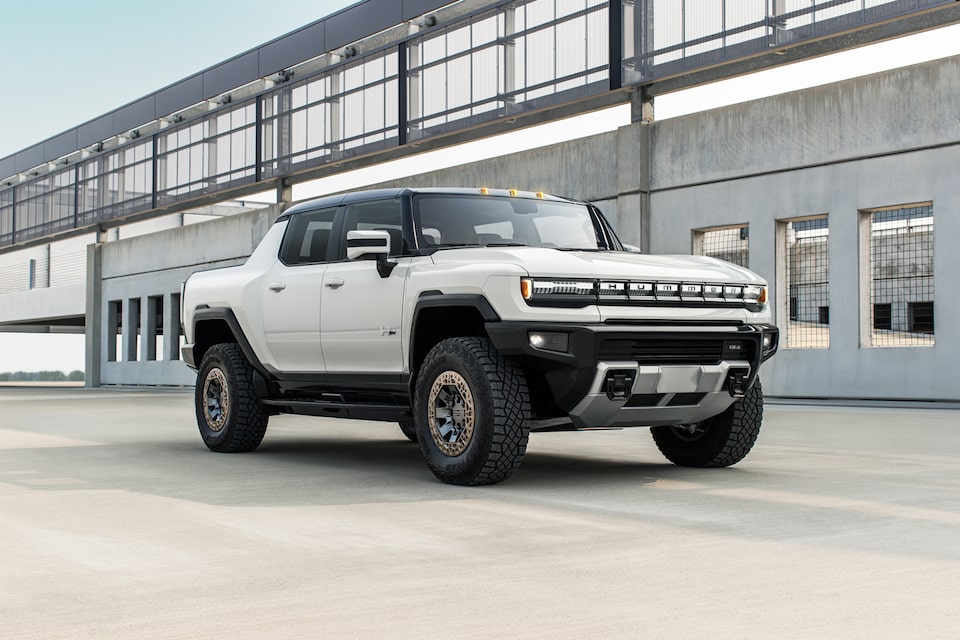 GMC Hummer EV SUV driving on the road.