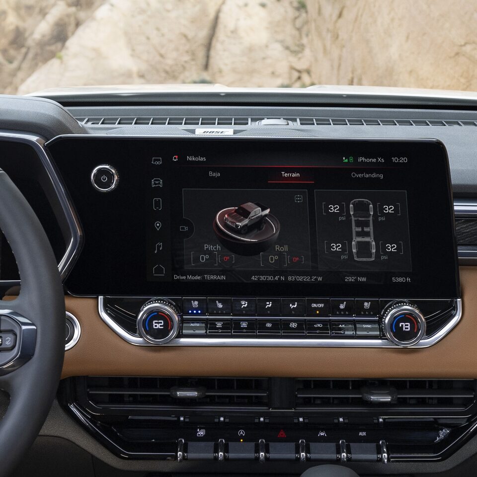 2023 GMC Canyon AT4 front interior featuring the HUD and infotainment system.