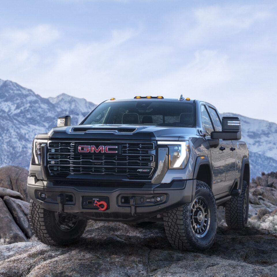The 2024 Sierra HD AT4X AEV Edition parked atop craggy rocks.