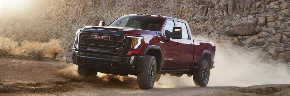 The 2024 GMC Sierra HD AT4X kicking up dirt.