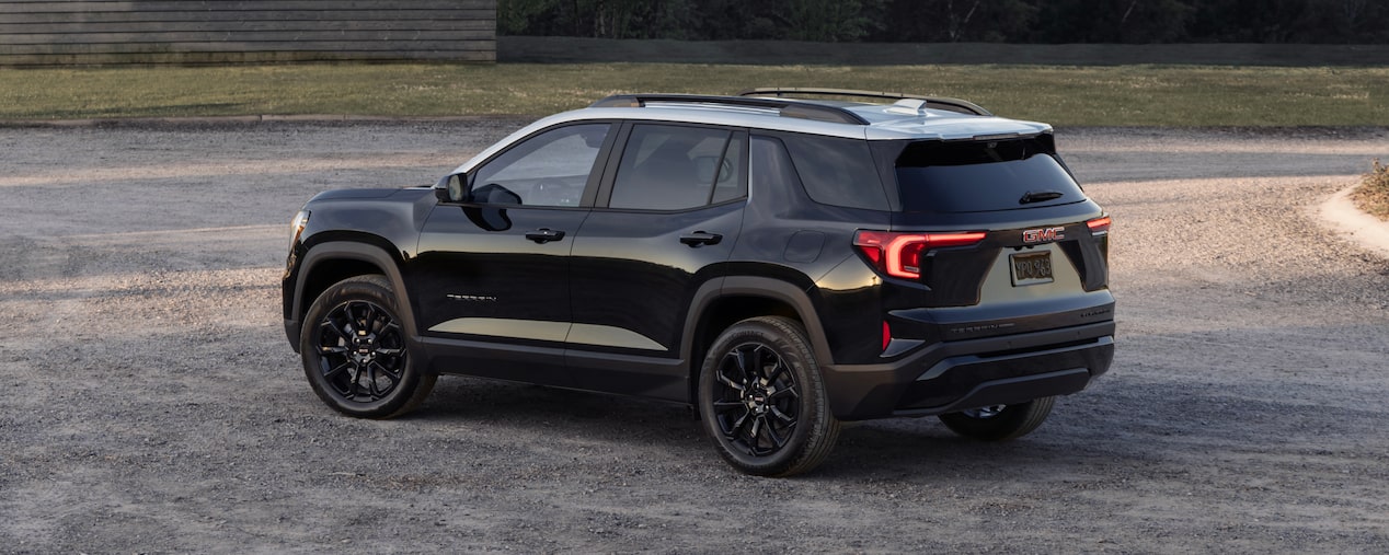 Back-side view of the 2025 GMC Terrain parked outdoors alone.
