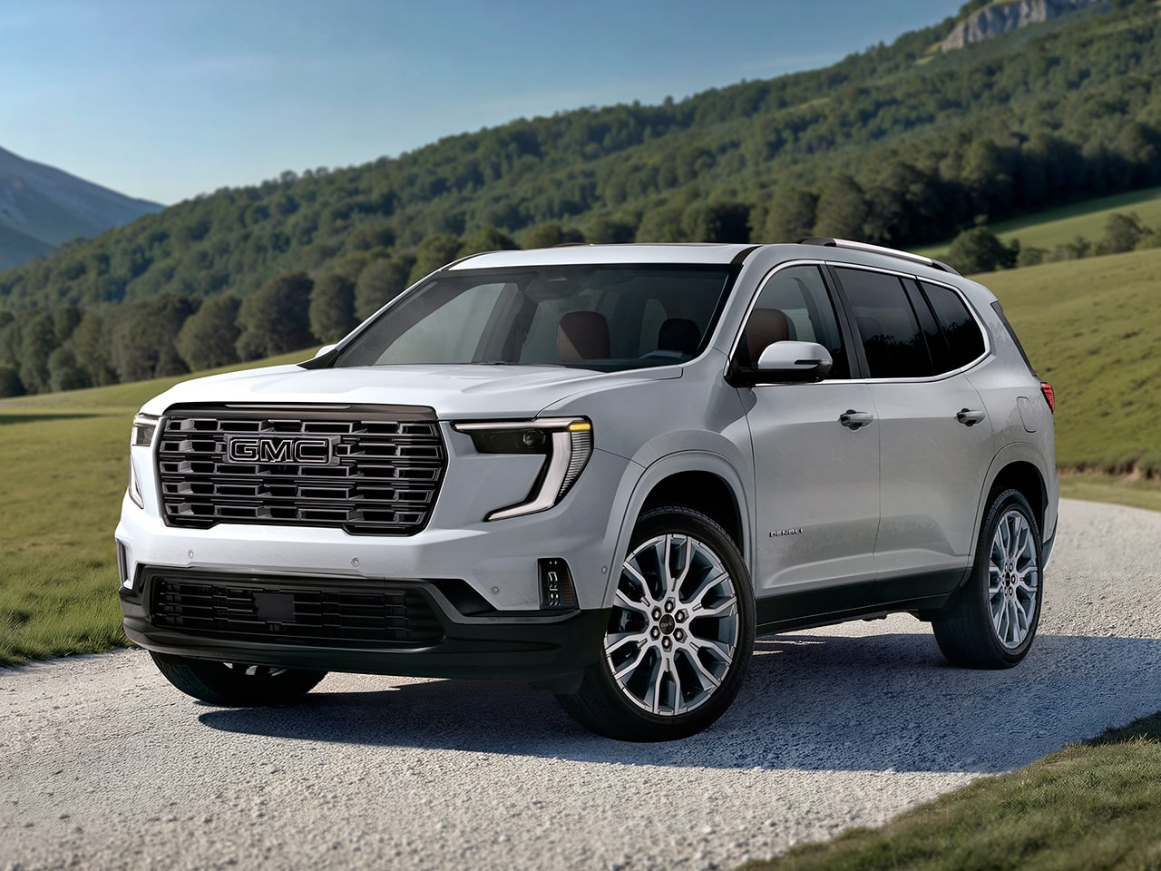 Vue latérale avant du GMC Acadia Denali 2026 stationné seul à l’extérieur.