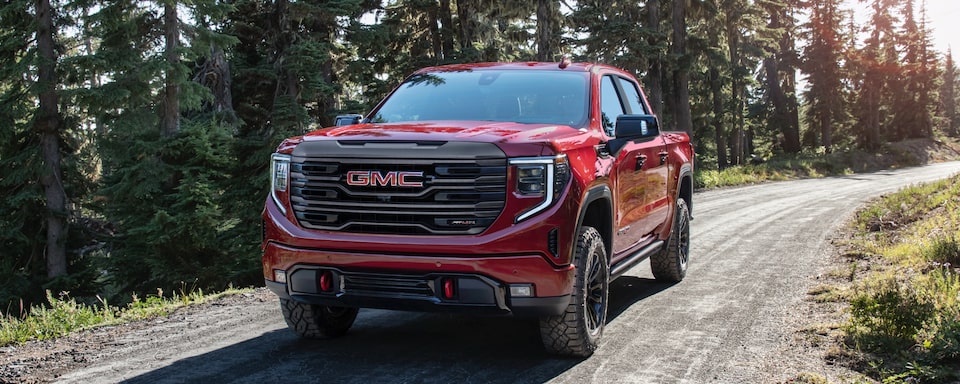 2022 GMC Sierra AT4X driving outdoors.