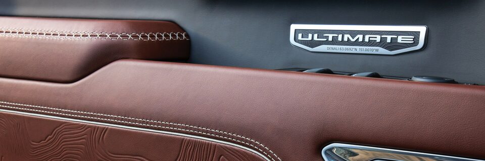 2022 GMC Sierra Exclusive Denali Ultimate metal badging on seatbacks and doors.