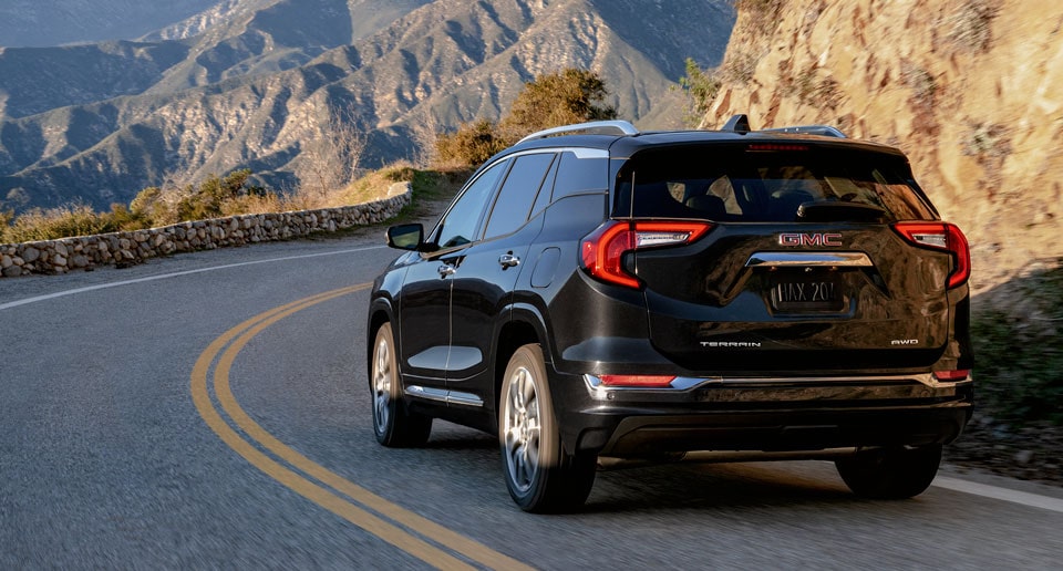 GMC SUV Driving on Cliffside Road