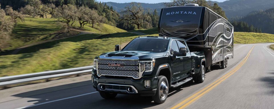 2022 Sierra HD Denali towing and driving on the road.