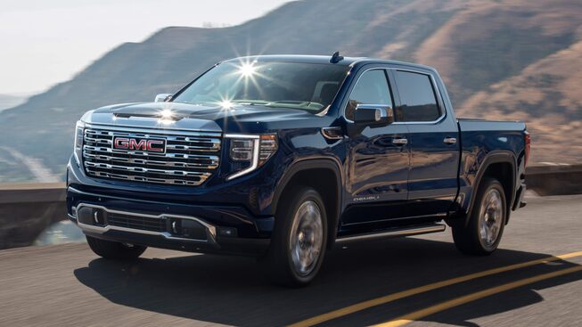 Sierra 1500 Denali 2023 sur une route de campagne longeant une rivière.